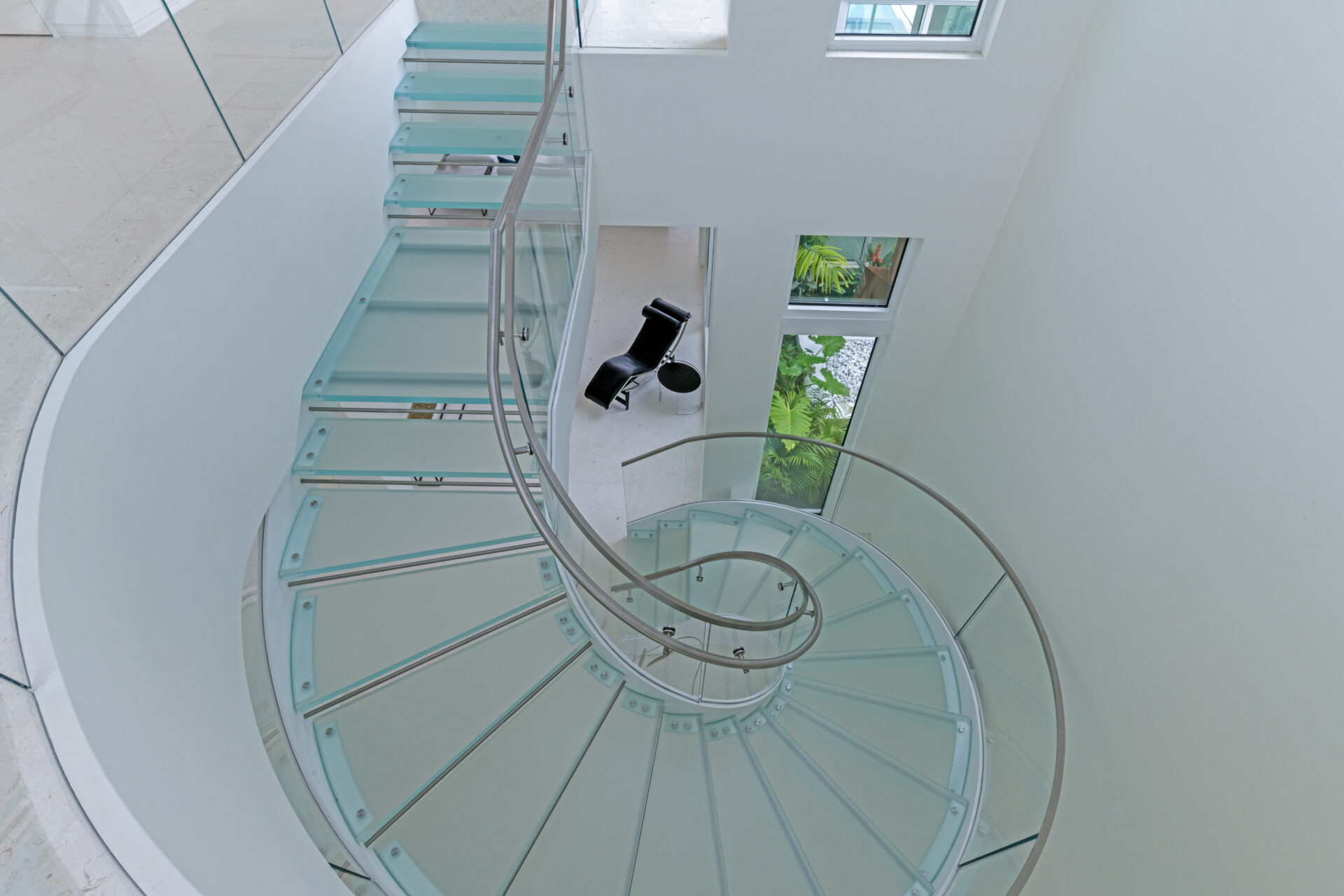 A spiral staircase with glass panels