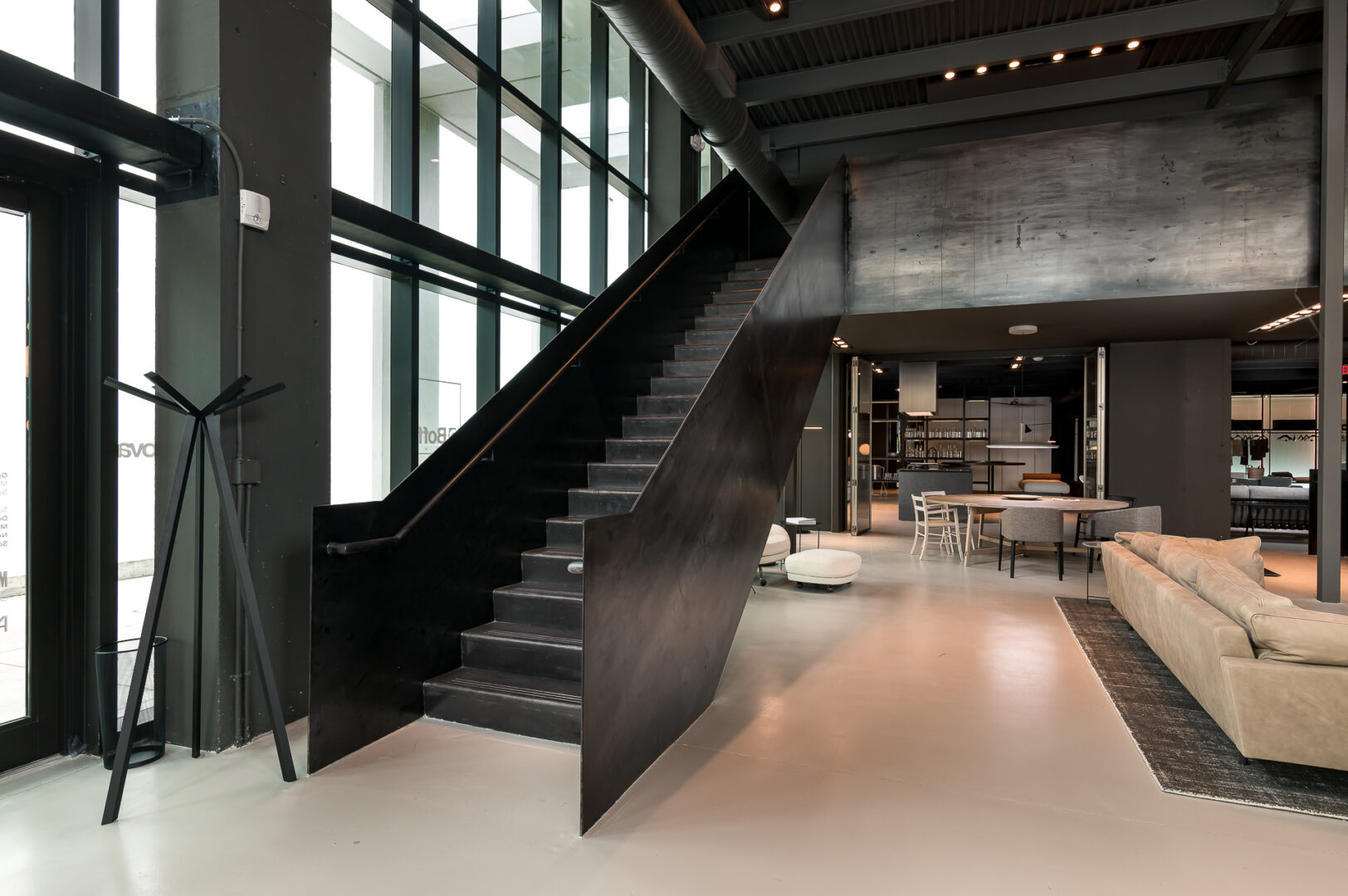 A black staircase connected to a lounge