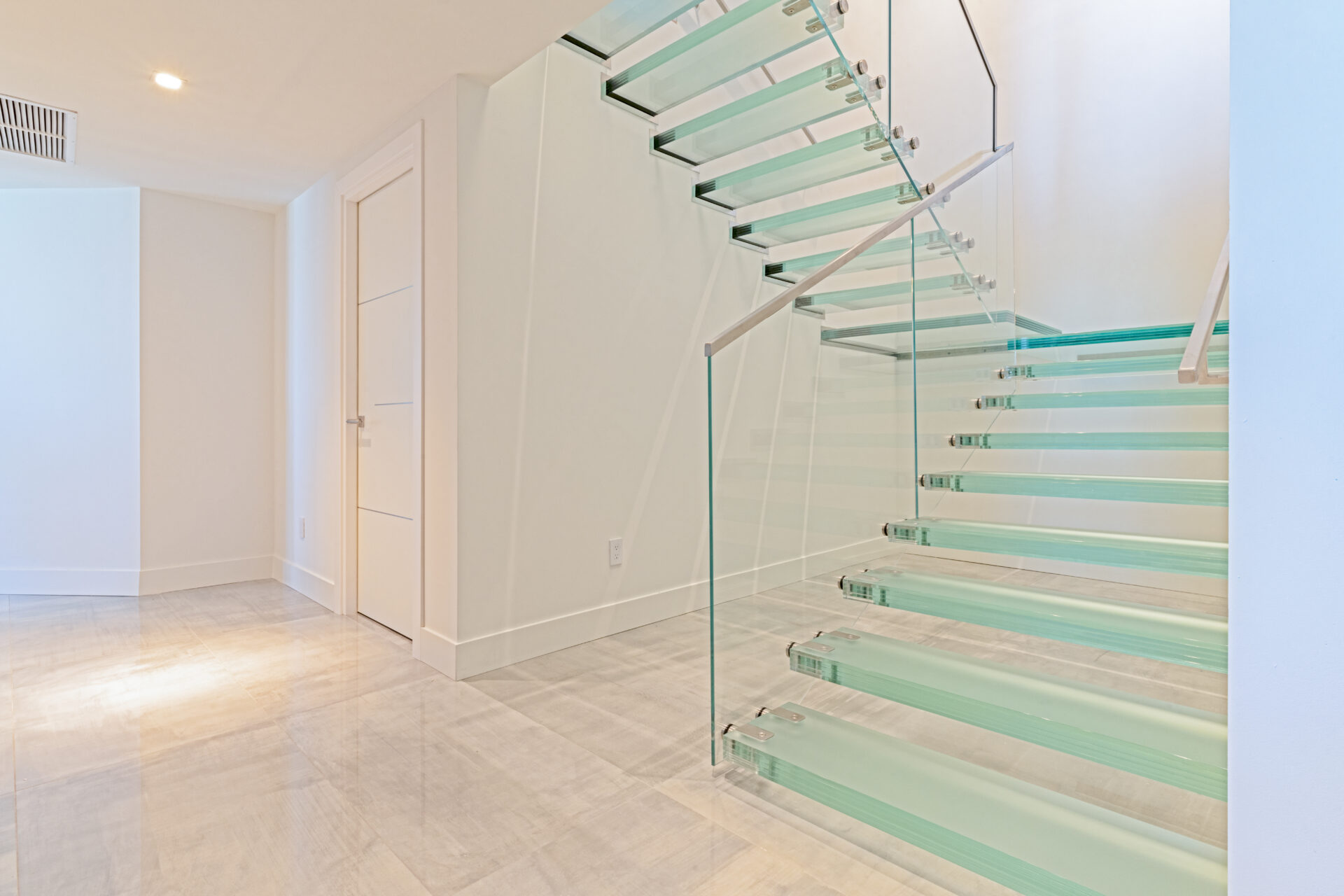 A staircase with glass steps and panels